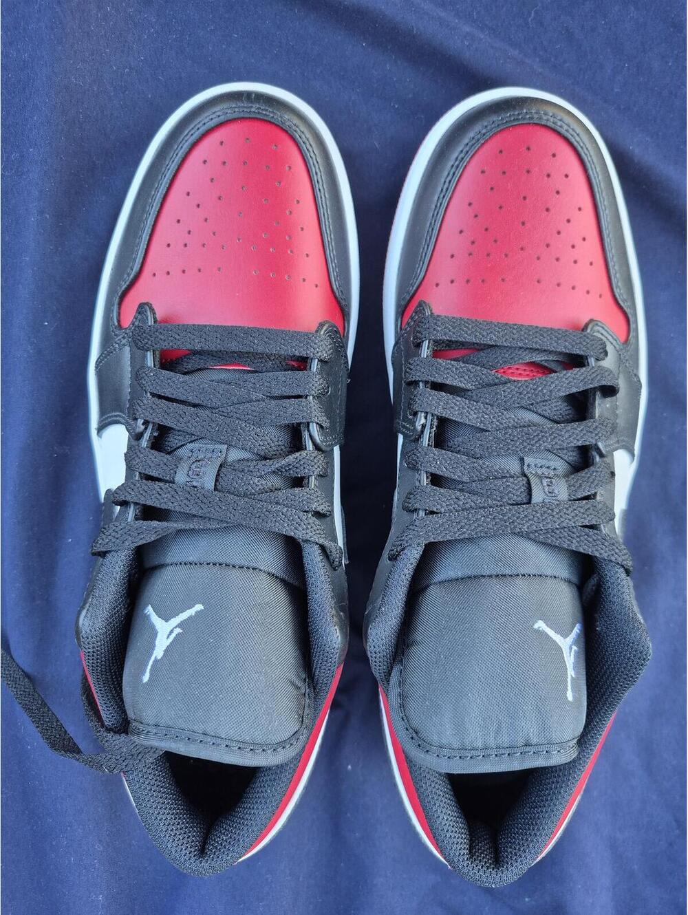Air Jordan 1 Low silhouette in a black, white, and red 9 M